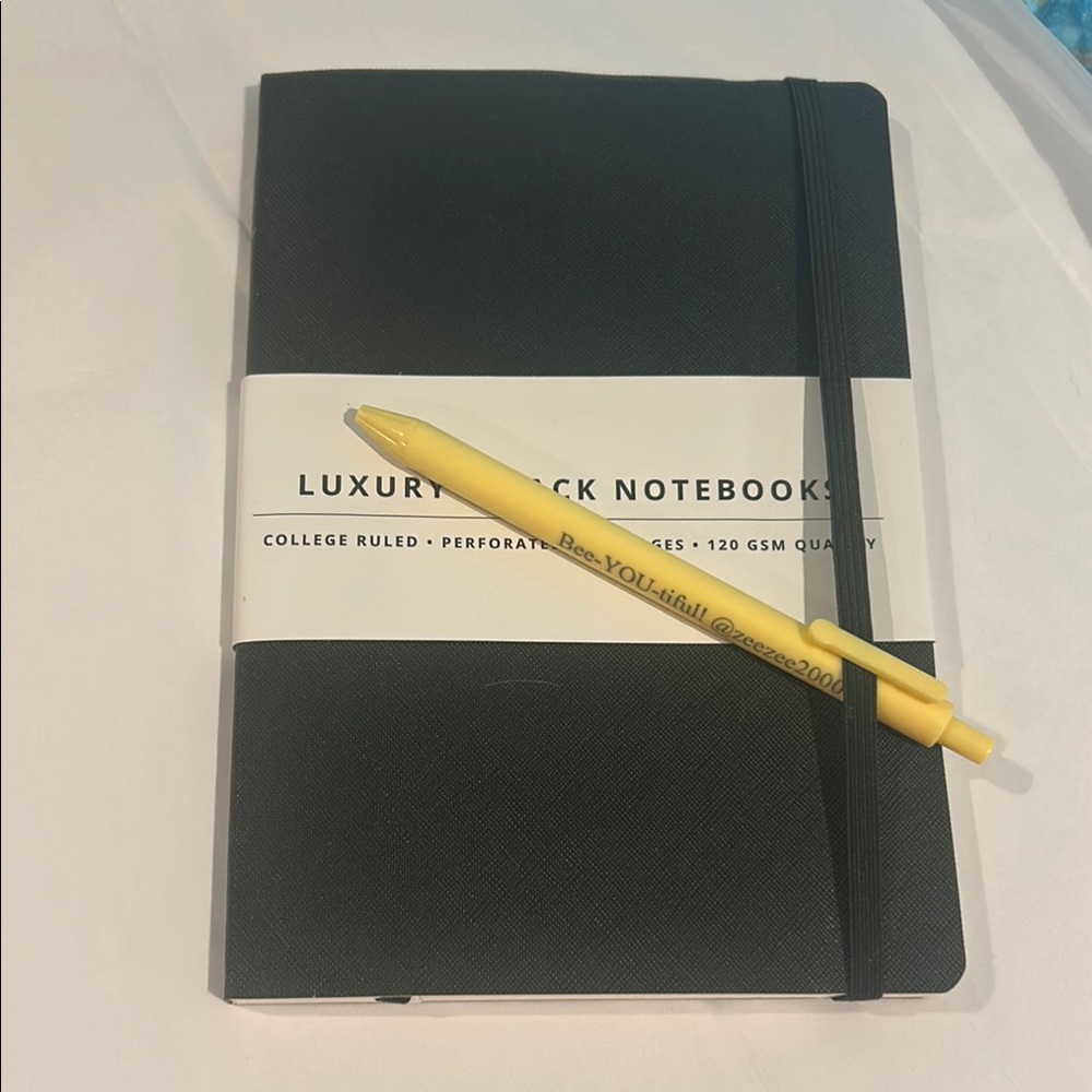 Black Notebook with Yellow Pen